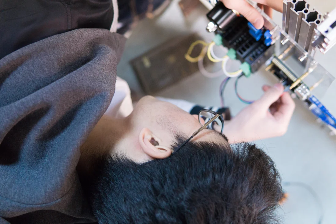 Yize Wang working on a mechatronics project